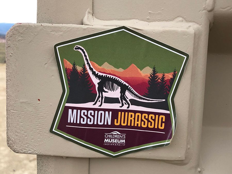 A sticker featuring the official Mission Jurassic logo